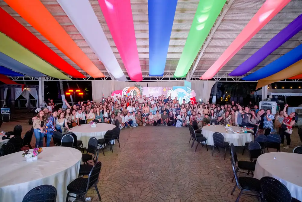 Hundreds of ResolvedCX team members under colorful canopies at a company event
