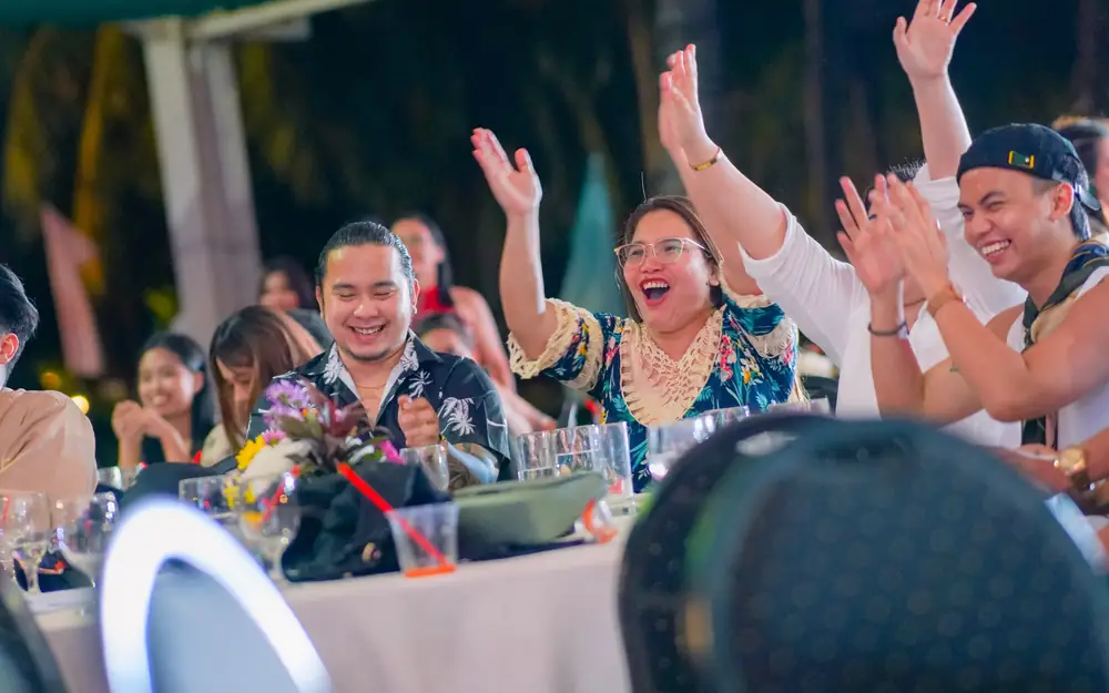 ResolvedCX team members cheering at a company gathering