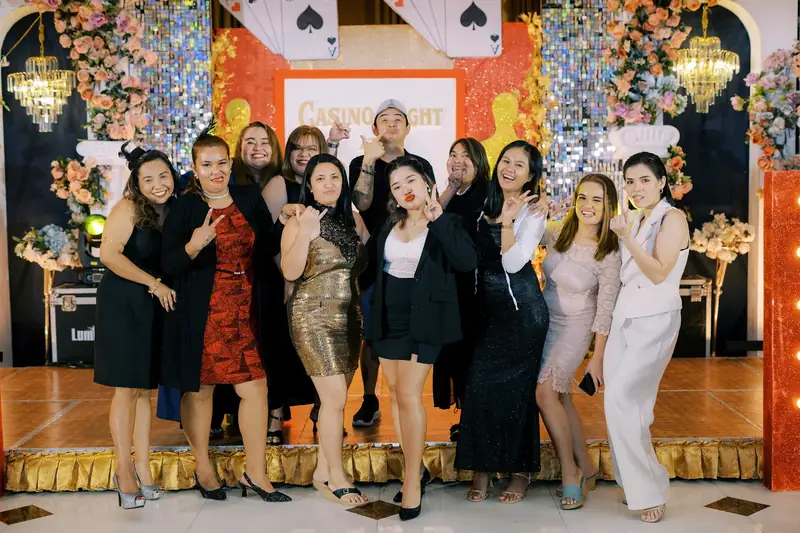 A group of ResolvedCX teammates at a casino-night themed event