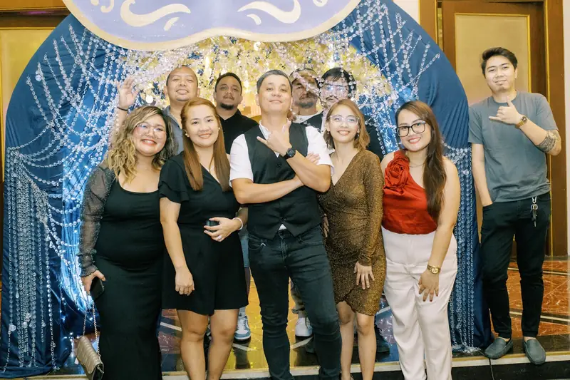 ResolvedCX teammates posing at a masquerade-themed event